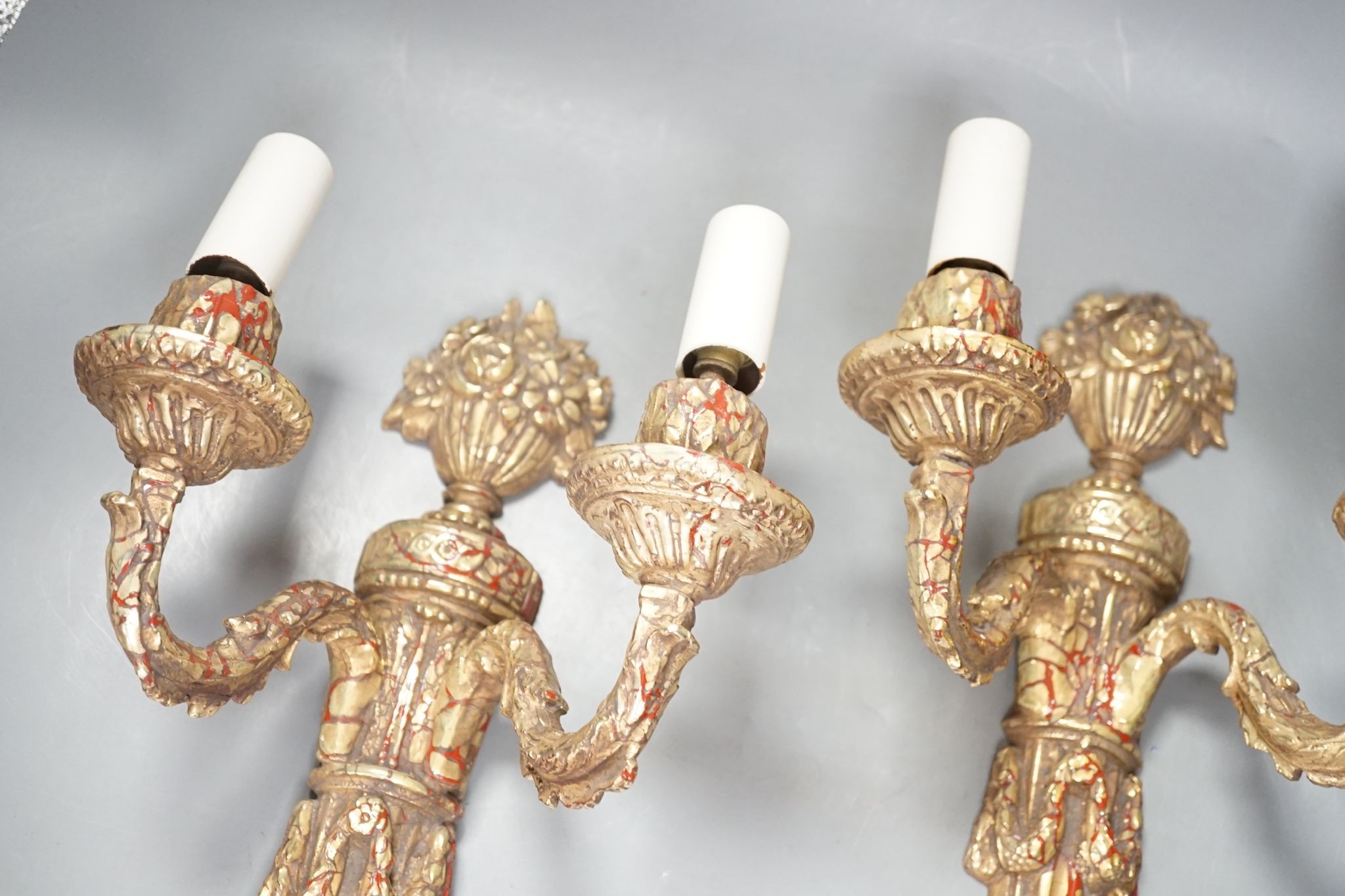 A pair of neo-classical style gilt composition twin-light wall sconces, 38cm